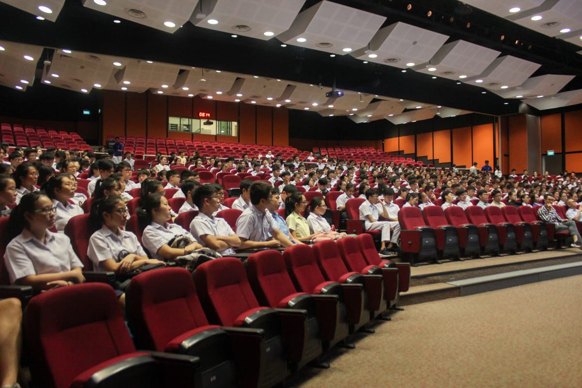 Students attending a talk at the school auditorium